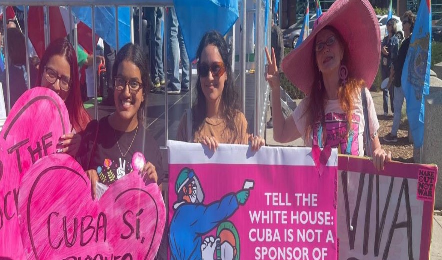 cuba solidarity activists with pink hearts placards and banners