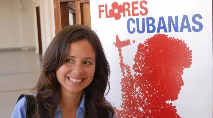 Female cuban activist in front of the poster