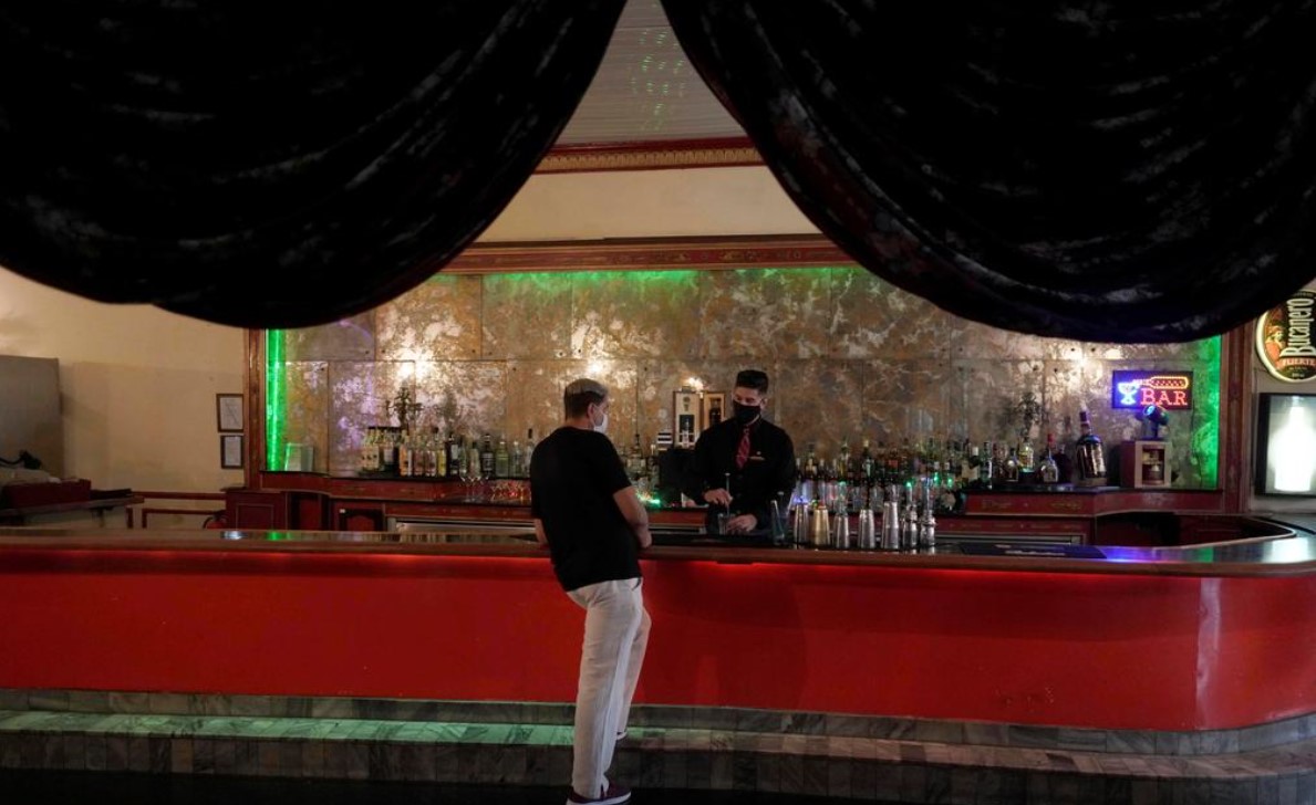 A barman chats with a colleague at a state-owned restaurant in Havana, Cuba, November 16, 2020. Photo taken on November 16, 2020. REUTERS/Alexandre Meneghini/Files